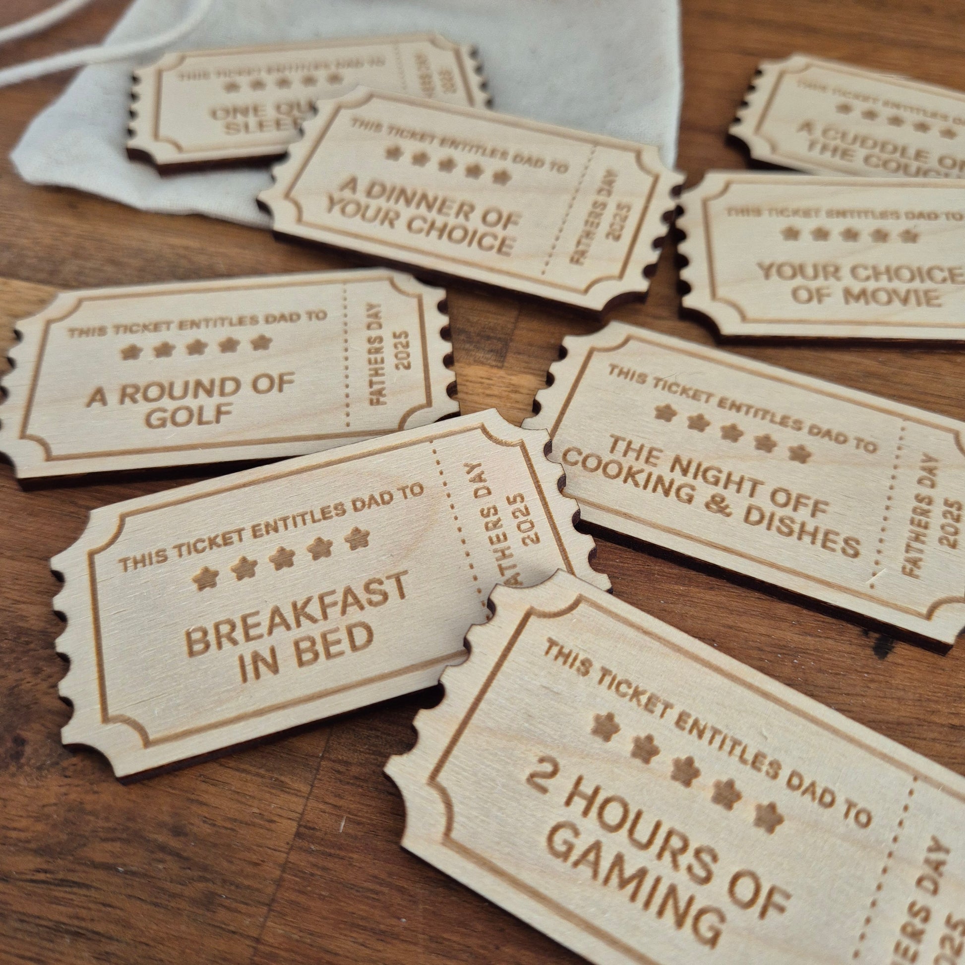 Wooden Father's Day Coupons with various activities on a wooden surface