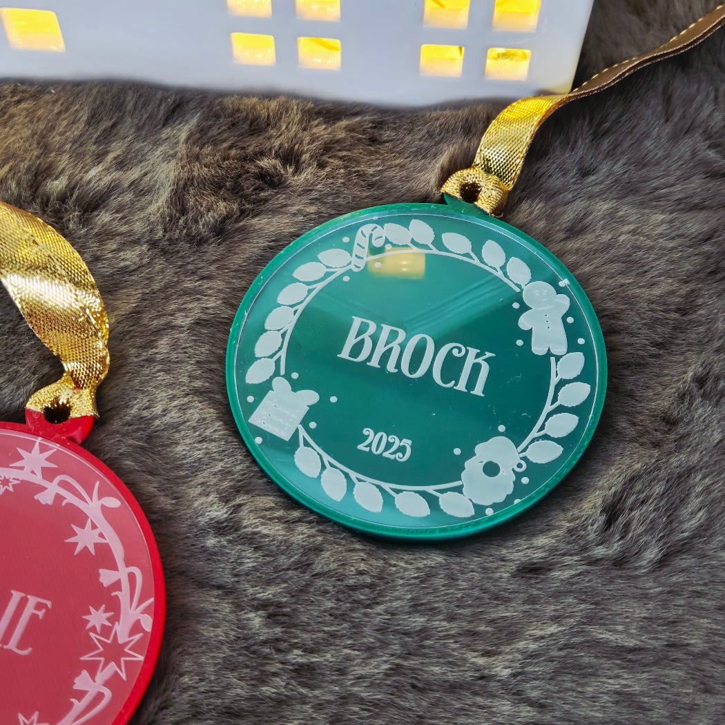 Decorative round ornaments with names on a textured surface