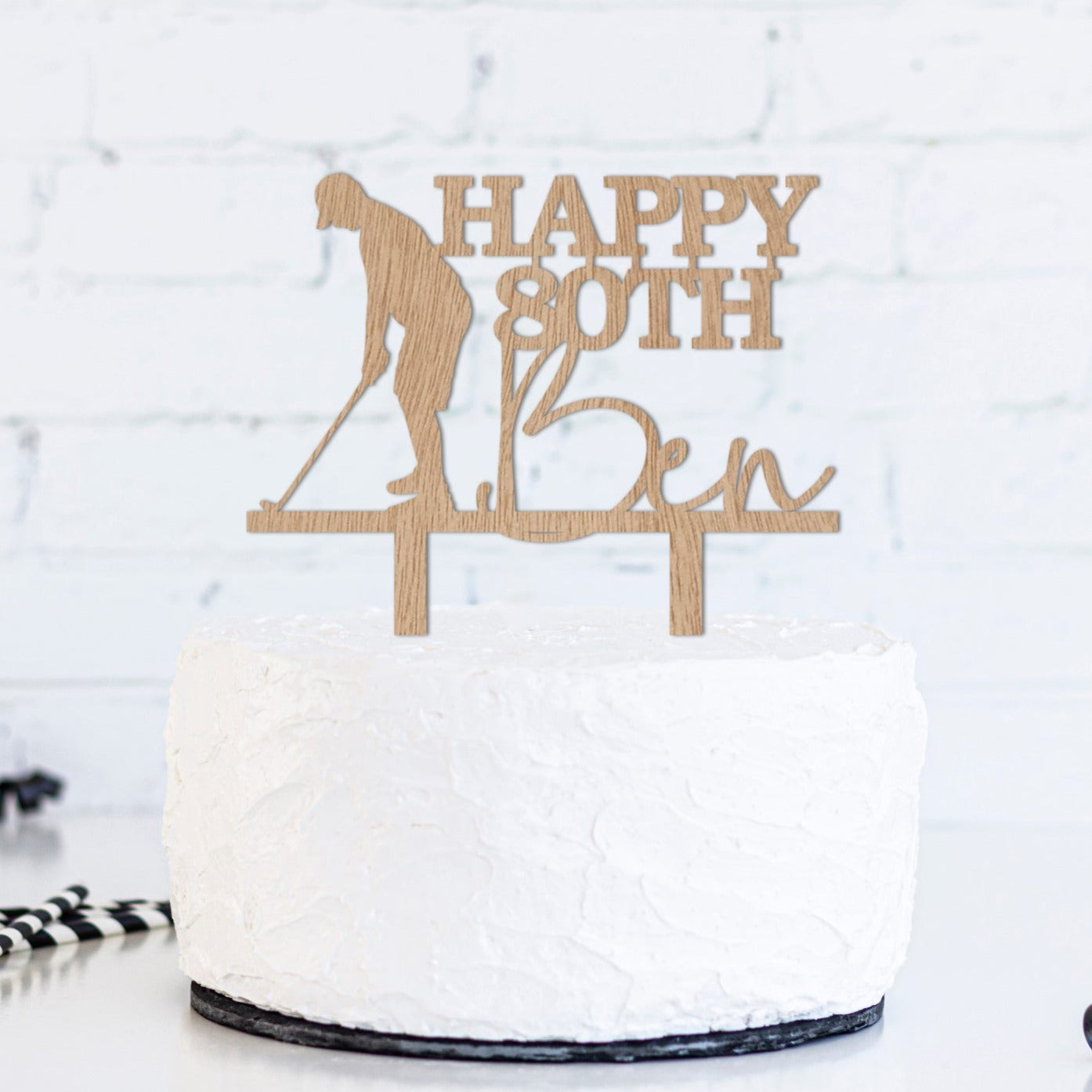 Wooden cake topper featuring a silhouette of a golfer about to take a swing