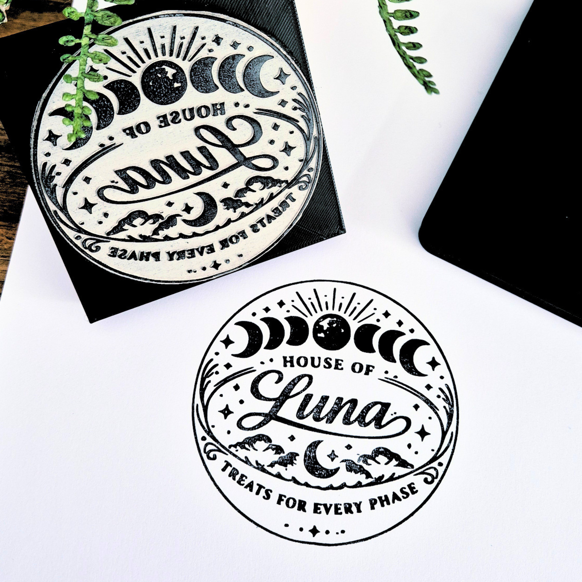Handheld Stamp with 'House of Luna' design on a white surface with black border