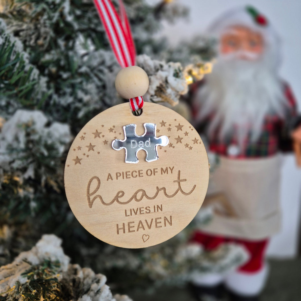 Decorative Christmas ornament with a puzzle piece and engraved text on a Christmas tree.