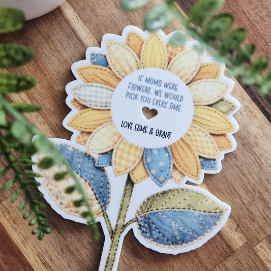 Flower-shaped sticker with text on a wooden surface