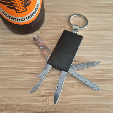 Black Keyring with scissors, ruler, nail file, bottle opener and knife. Can be custom engraved.